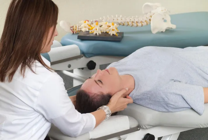 Chiropractic Merritt Island FL Female Chiropractor Checking Woman's Neck